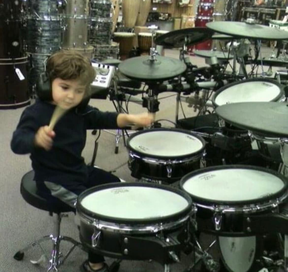 Ryan as a young child playing an electronic drum kit