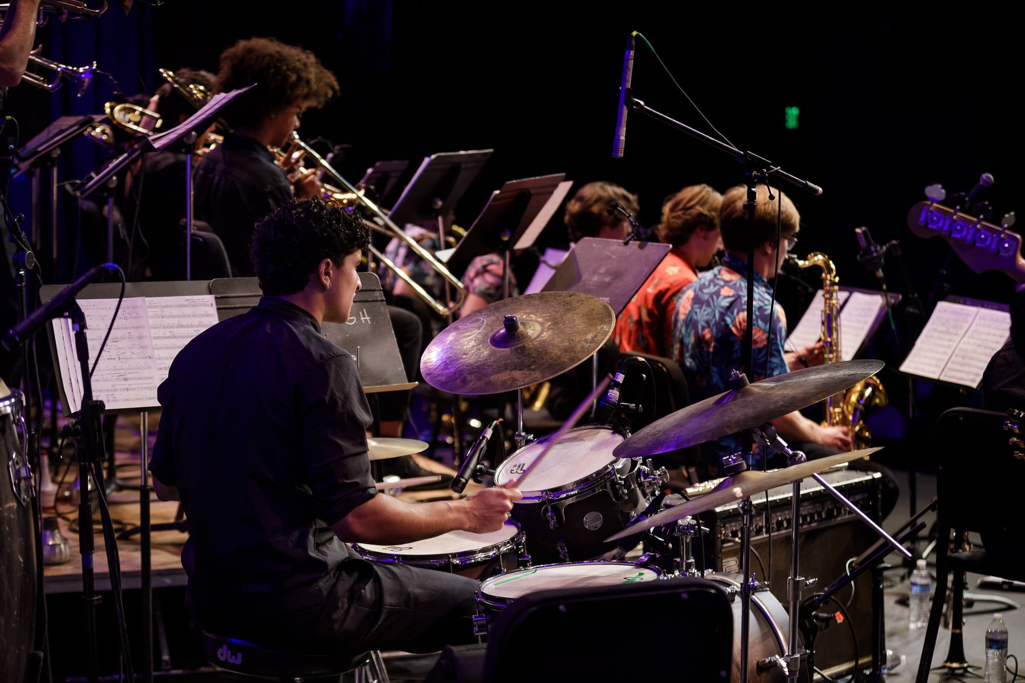 Ryan performing on drums with a big band ensemble